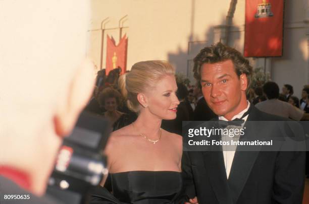 American actor Patrick Swayze and his wife, actress Lisa Niemi pose together on the red carpet outside the Shrine Civic Auditorium as they attend the...