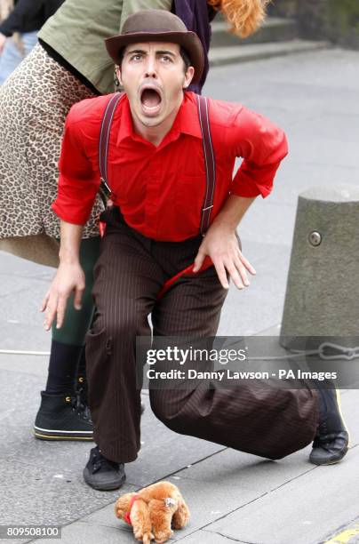 Performer promotes Edinburgh Fringe Festival show Howling Moon on Edinburgh's Royal Mile on the last day of the festival.