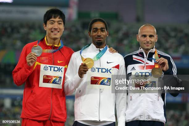 S Jason Richardson who won Gold, China's Liu Xiang who won Silver and Great Britain's Andrew Turner who won Bronze pose on the podium for the Men's...