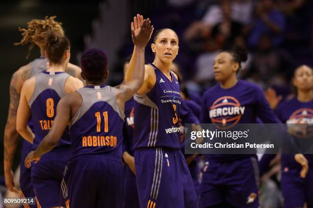 Diana Taurasi of the Phoenix Mercury high fives Danielle Robinson after scoring against the Washington Mystics during the second half of the WNBA...