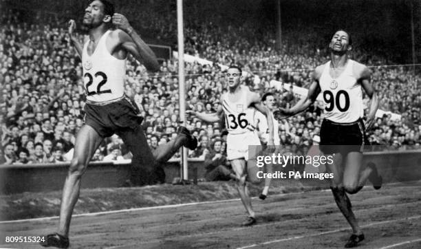 Arthur Wint , of Jamaica, B.W.I., wins the Summer Olympic 400-meter dash at Wembley Stadium, Eng, leading his teammate Herb McKenley who placed...