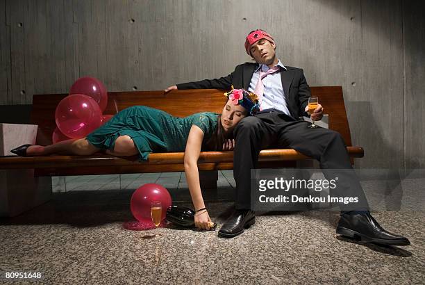 exhausted drunk couple passed out from partying - hangover stockfoto's en -beelden
