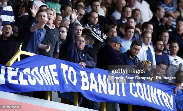 Fans hold banners in the stands during the npower Football League Championship match at the Den, London.