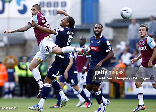 West Ham's Henri Lansbury jumps with Millwall's Tamika Mkandawire for the ball during the npower Football League Championship match at the Den,...