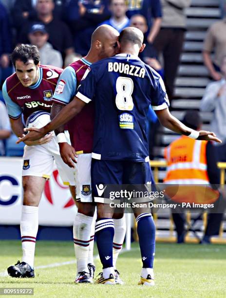 West Ham's Julien Faubert and Millwall's Hamer Bouazza have words during the npower Football League Championship match at the Den, London.