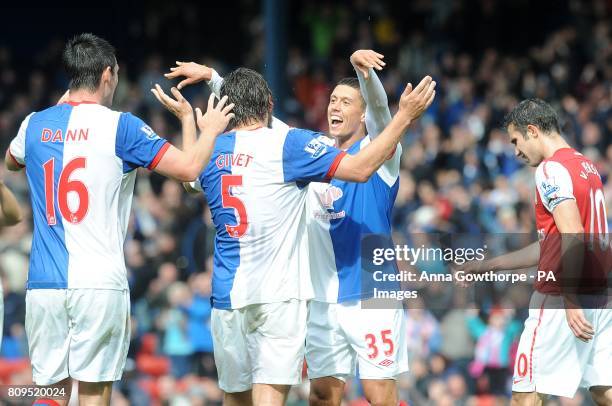 Blackburn Rovers' Scott Dann, Gael Givet and Jason Lowe celebrate victory as Arsenal's Robin van Persie stands dejected