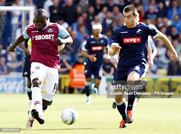 West Ham's Henri Lansbury in action with Millwall's Tamika Mkendawire during the npower Football League Championship match at the Den, London.