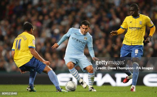 Manchester City's Carlos Tevez takes on the Birmingham City defence during the Carling Cup, Third Round match at the Etihad Stadium, Manchester.