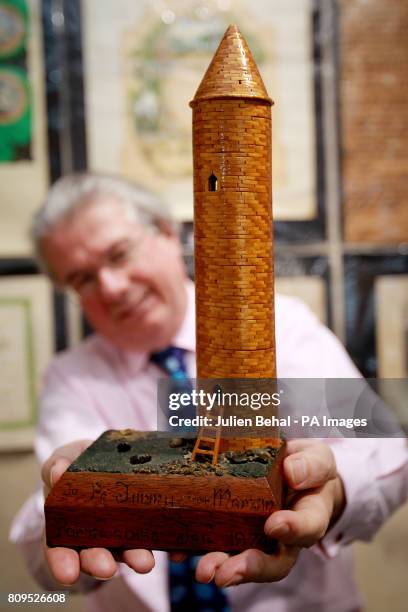 Ian Whyte of Whyte's Auctioneers in their showrooms in Dublin with an Irish round tower made from matchsticks by Sinn Fein Presidential candidate...