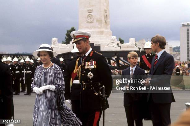 Queen Elizabeth II and the Duke of Edinburgh, with Prince Andrew and Prince Edward, when she reviewed the Royal Marines at Plymouth Hoe, during her...