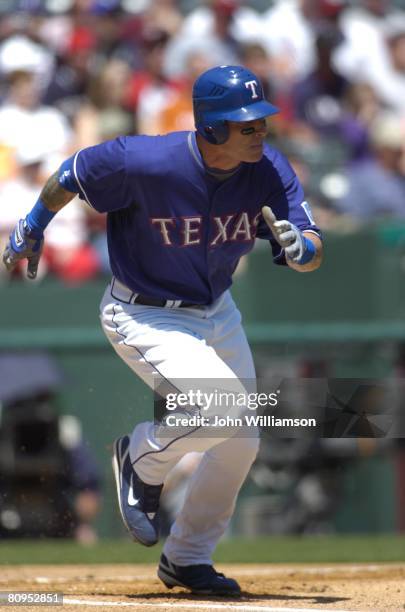 Josh Hamilton of the Texas Rangers runs to first base after hitting the ball during the game against the Toronto Blue Jays at Rangers Ballpark in...