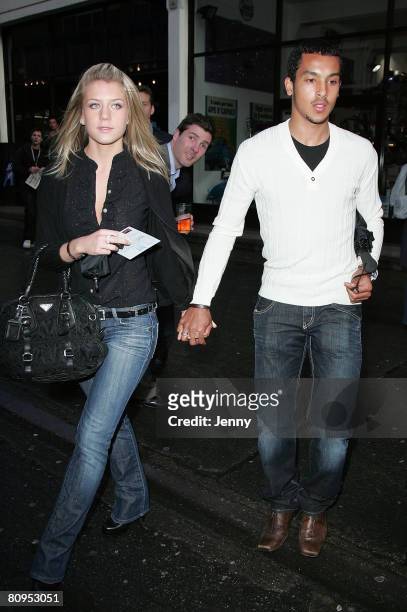 Melanie Slade and Theo Walcott attend Get Britain Breastfeeding Private View in East London on May 1, 2008 in London, England.