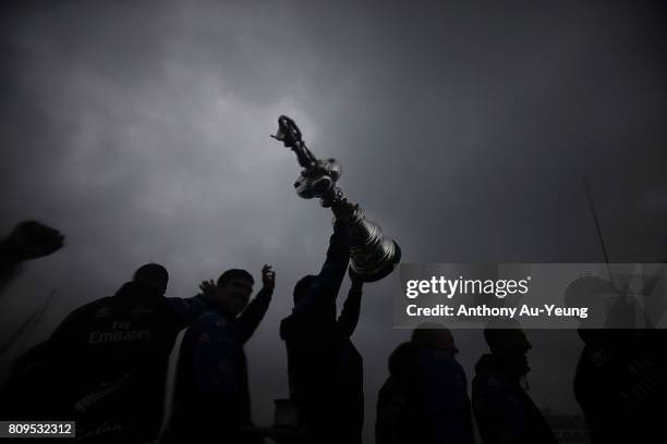 Members of Emirates Team New Zealand showcase the America's Cup trophy to the supporters during the Team New Zealand Americas Cup Welcome Home Parade...