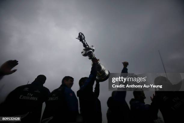 Members of Emirates Team New Zealand showcase the America's Cup trophy to the supporters during the Team New Zealand Americas Cup Welcome Home Parade...