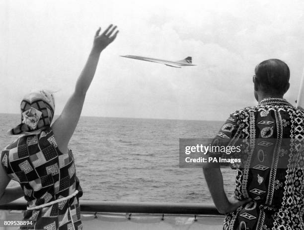 Queen Elizabeth II and the Duke of Edinburgh wave as Concorde flies by the Royal Yacht Britannia as the royal couple neared Barbados.