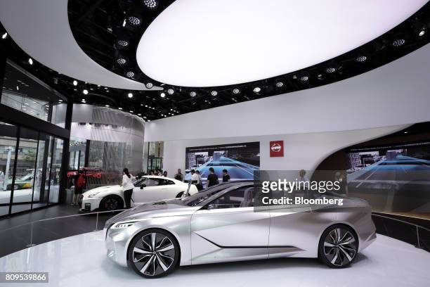 The Nissan Motor Co. Vmotion 2.0 concept vehicle, right, and the GT-R Nismo vehicle stand on display at the company's Nissan Crossing showroom in the...
