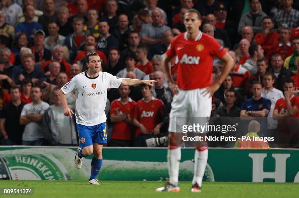 Basle's Alexander Frei celebrates scoring as Manchester United's Rio Ferdinand stands dejected