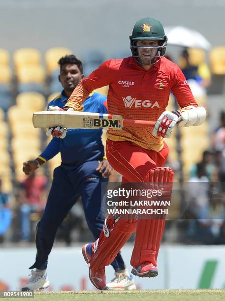 Zimbabwe cricketer Malcolm Waller runs between the wickets as Sri Lankan cricketer Wanidu Hasaranga look on during the third one-day international...