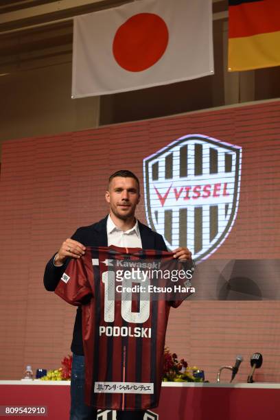 Vissel Kobe new player Lukas Podolski poses with his new jersey during a press conference on July 6, 2017 in Kobe, Hyogo, Japan.