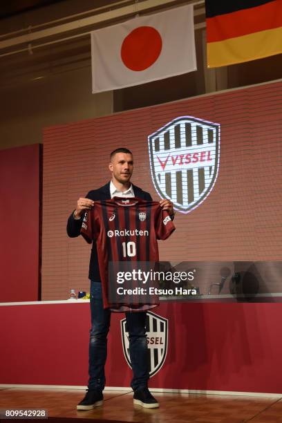 Vissel Kobe new player Lukas Podolski poses with his new jersey during a press conference on July 6, 2017 in Kobe, Hyogo, Japan.