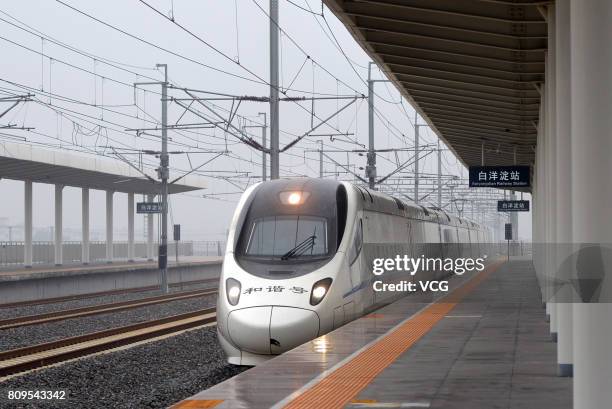 The high speed train D6655 from Beijing South Railway Station arrives at Baiyangdian Railway Station in Xiongan New Area on July 6, 2017 in Baoding,...