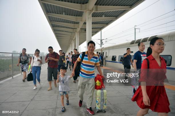 Passengers get off the first high speed train D6655 at Baiyangdian Railway Station in Xiongan New Area on July 6, 2017 in Baoding, Hebei Province of...