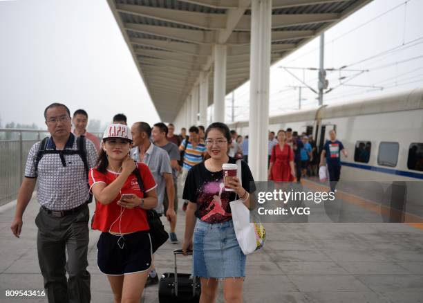 Passengers get off the first high speed train D6655 at Baiyangdian Railway Station in Xiongan New Area on July 6, 2017 in Baoding, Hebei Province of...