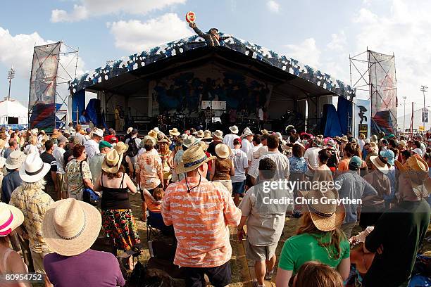 Fans listen to the New Orleans Nightcrawlers Brass Band perform on the Jazz and Heritage stage during the New Orleans Jazz and Heritage Festival at...