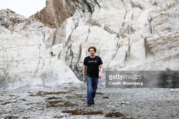Marcus Hutchins, digital security researcher for Kryptos Logic, walks along Tunnels Beaches in Ilfracombe, U.K., on Tuesday, July 4, 2017. Hutchins,...