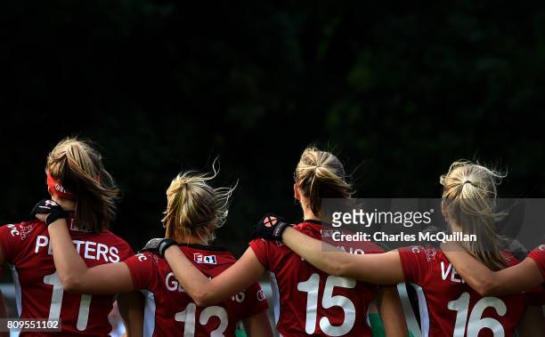 The Belgian players link arms as they sing their national anthem during the Fintro Hockey World League Semi-Final tournament on June 27, 2017 in...