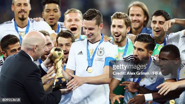 President Gianni Infantino hands over the trophy to team captain Julian Draxler of Germany after the FIFA Confederations Cup Russia 2017 final...