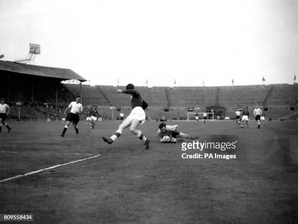 Great Britain's goalkeeper Mike Pinner falls on the ball as he saves from Georgi Dimitrov, Bulgaria's inside right in the Olympic Games qualifying...