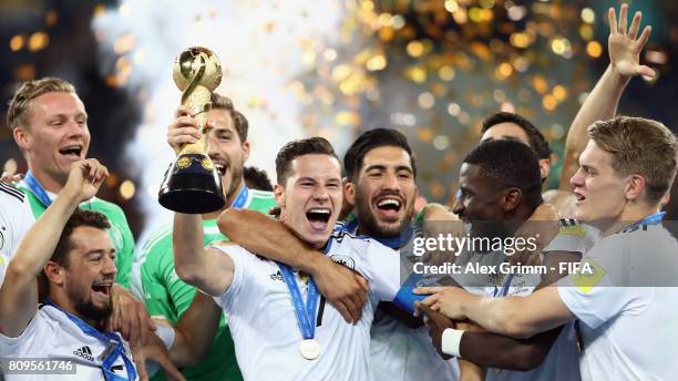 Julian Draxler of Germany lifts the FIFA Confederations Cup trophy after the FIFA Confederations Cup Russia 2017 final between Chile and Germany at...