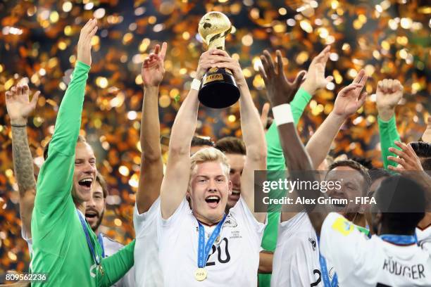 Julian Brandt of Germany lifts the FIFA Confederations Cup trophy after the FIFA Confederations Cup Russia 2017 final between Chile and Germany at...