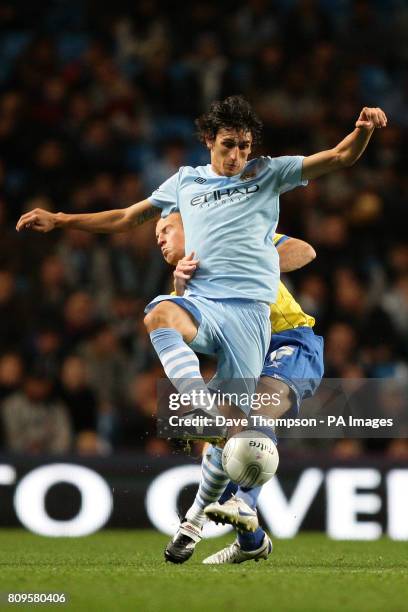 Manchester City's Stefan Savic and Birmingham City's Adam Rooney in action