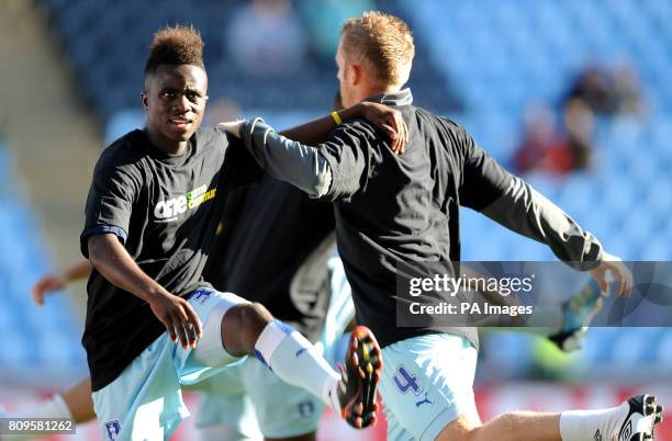 Coventry City's Gael Bigirimana and Sammy Clingan wear 'One Community' T-shirts during the warm up before the npower Football League Championship...