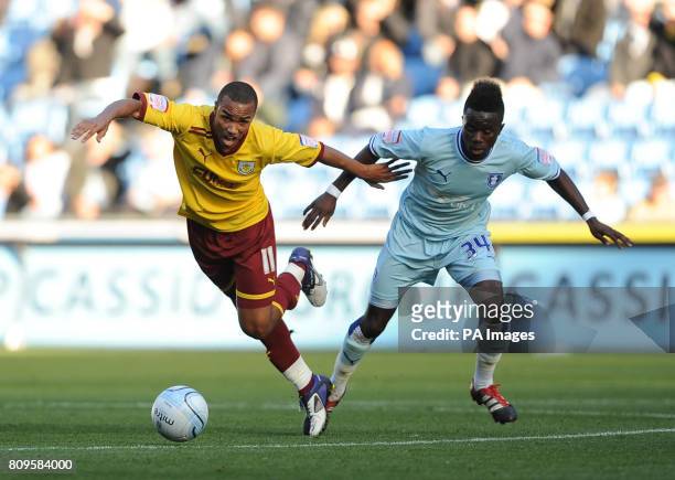Coventry City's Gael Bigirimana and Burnley's Junior Stanislas in action during the npower Football League Championship match at the Ricoh Arena,...