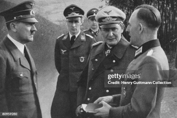 Nazi leader Adolf Hitler with commander in chief of the Luftwaffe, Hermann Goering and Hitler's Chief adjutant Lieutenant Colonel Rudolf Schmundt...
