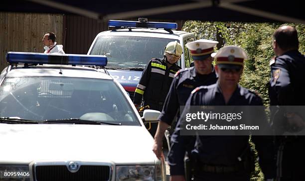 Policemen and members of the firebrigade are seen at the backside of the house, where a father imprisoned his daughter for 24 years and had seven...