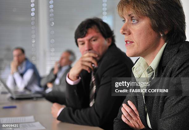 International Cycling Union doctor Mario Zorzoli listens to manager of the UCI's anti-doping services team Anne Gripper during a press conference to...