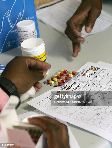 Nurse at an anti-retroviral clinic in Emmaus hospital in the town of Winterton, Kwazulu-Natal region, South Africa explains to a patient how he...