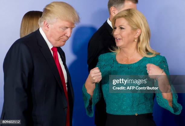 President Donald Trump speaks with Croatian President Kolinda Grabar-Kitarovic following a family photo for participants of the Three Seas Initiative...