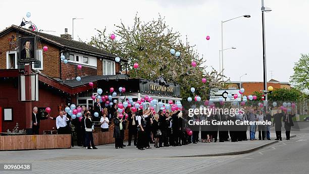 West Ham United supporters pay their respects as the coffin of Chelsea footballer Frank Lampards mother Pat is driven past on May 2, 2008 in Barking,...