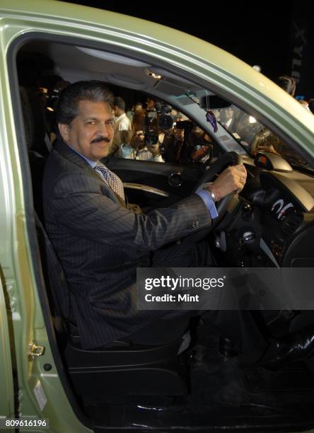 Anand Mahindra, Vice president of Mahindra & Mahindra Auto, sits on the front seat of Newly launched Mahindra Xylo car at the company's plant in...