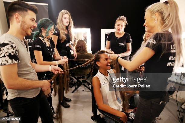 Model gets her hair done backstage ahead of the 'Designer for Tomorrow' show during the Mercedes-Benz Fashion Week Berlin Spring/Summer 2018 at...