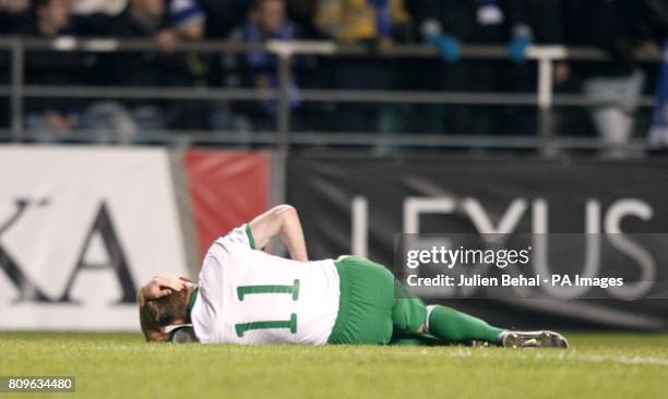 Republic of Ireland's Damien Duff lies injured on the pitch