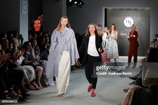 Designer Lara Krude is seen with a model on the runway after accepting the fashion talent award 'Designer for Tomorrow' by Peek & Cloppenburg and...