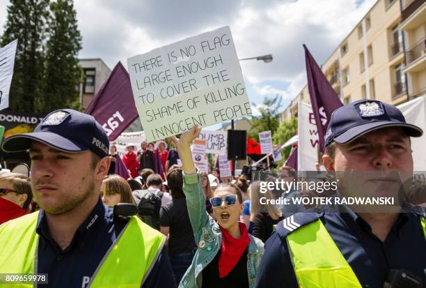 Demonstrators protest against the visit of US President Donald Trump in Warsaw, on July 6, 2017. - Donald Trump embarks on a high-stakes visit to...