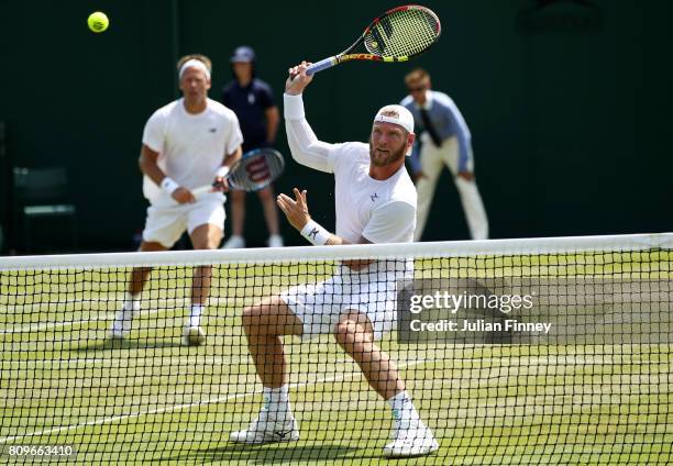 Sam Groth of Australia plays a plays a forehand during the Gentlemen's Doubles first round match with Robert Lindstedt of Sweden against Guillermo...