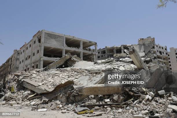 Picture shows destroyed buildings in Aleppo's northwest Layramoun industrial district on July 5, 2017. - Six months after Syria's army captured the...